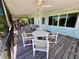 Inviting screened-in porch with a ceiling fan and outdoor furniture setting at 9270 Little Gasparilla Is, Placida, FL 33946