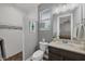 Well-lit bathroom featuring a walk-in shower with pebble floor, a granite countertop, and coastal decor at 9532 Miami Cir, Port Charlotte, FL 33981