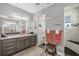 Elegant bathroom featuring double sink vanity with granite countertop and a spacious, tiled walk-in shower at 9532 Miami Cir, Port Charlotte, FL 33981