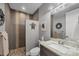 Bathroom features tiled walk-in shower, granite countertop, and sea turtle wall decor at 9532 Miami Cir, Port Charlotte, FL 33981