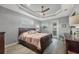Cozy bedroom features a tray ceiling, ceiling fan, and ample natural light with a connecting exterior door at 9532 Miami Cir, Port Charlotte, FL 33981