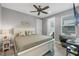 Light and airy bedroom with a king-sized bed, ceiling fan, and an attached ensuite bathroom at 9532 Miami Cir, Port Charlotte, FL 33981
