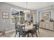 This naturally lit dining area features a round table, seating for six, and a decorative buffet at 9532 Miami Cir, Port Charlotte, FL 33981