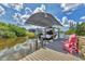 View of boat in the boat lift at the private dock with seating and beautiful waterfront at 9532 Miami Cir, Port Charlotte, FL 33981
