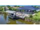 Scenic view of a waterfront home featuring a private dock, boat lift, and pool at 9532 Miami Cir, Port Charlotte, FL 33981