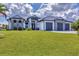 Beautiful single-Gathering home showcasing a 3-car garage, well-manicured lawn, and decorative stone facade at 9532 Miami Cir, Port Charlotte, FL 33981