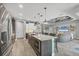 Kitchen with a center island, stainless appliances, and open access to the living room, ideal for gatherings at 9532 Miami Cir, Port Charlotte, FL 33981