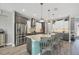 Bright kitchen features stainless appliances, a center island with seating, and modern pendant lighting at 9532 Miami Cir, Port Charlotte, FL 33981