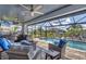 Relaxing screened lanai with outdoor kitchen, comfortable seating, and a lovely pool view at 9532 Miami Cir, Port Charlotte, FL 33981