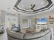 Open concept living area featuring hardwood floors, stylish furnishings, and views of the entryway at 9532 Miami Cir, Port Charlotte, FL 33981