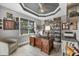 The cozy office has a dark brown wooden desk, an organized shelf, and golf clubs stored nearby at 9532 Miami Cir, Port Charlotte, FL 33981