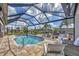 Screened pool with beautiful brick deck, canal view, and outdoor lounge seating at 9532 Miami Cir, Port Charlotte, FL 33981