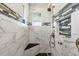 Contemporary shower features marble-style tiling, black accent tiles, and a built-in shower seat at 9532 Miami Cir, Port Charlotte, FL 33981