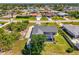 An aerial view of a home with a screened pool and lush, well-maintained landscaping at 9869 Gulfstream Blvd, Englewood, FL 34224