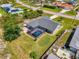 This is an aerial view of a home with a screened-in pool and well-manicured lawn at 9869 Gulfstream Blvd, Englewood, FL 34224
