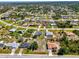 Aerial view of homes showcases neighborhood layout and the property's location within a residential community at 9869 Gulfstream Blvd, Englewood, FL 34224