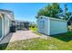 Expansive backyard featuring a shed, pool area, and lush lawn, perfect for outdoor living and entertaining at 9869 Gulfstream Blvd, Englewood, FL 34224