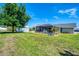 Expansive backyard featuring a shed, pool area, and lush lawn, perfect for outdoor living and entertaining at 9869 Gulfstream Blvd, Englewood, FL 34224