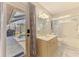Bathroom with view to pool area, features walk-in shower, vanity and light and neutral decor at 9869 Gulfstream Blvd, Englewood, FL 34224