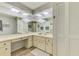 Bright bathroom featuring ample counter space, a large mirror, and plenty of storage at 9869 Gulfstream Blvd, Englewood, FL 34224
