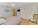Bedroom featuring hardwood floors, a ceiling fan, and ample closet space for organized storage at 9869 Gulfstream Blvd, Englewood, FL 34224