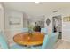 Comfortable dining area featuring a round wood table and four chairs at 9869 Gulfstream Blvd, Englewood, FL 34224
