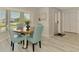 Well lit dining area with view of the window and nearby door and closet space at 9869 Gulfstream Blvd, Englewood, FL 34224
