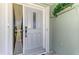 Welcoming front door with decorative window and secure keyless entry at 9869 Gulfstream Blvd, Englewood, FL 34224