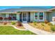 Close-up of home's entrance showcasing the front door and decorative landscaping at 9869 Gulfstream Blvd, Englewood, FL 34224
