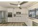 This modern kitchen features stainless steel appliances, white cabinets, and plenty of counter space at 9869 Gulfstream Blvd, Englewood, FL 34224