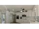 Inviting modern kitchen with white cabinets, stainless appliances, ample counter space, and a ceiling fan at 9869 Gulfstream Blvd, Englewood, FL 34224