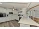 Modern kitchen features white cabinets, stainless steel appliances, and quartz countertops with outdoor views at 9869 Gulfstream Blvd, Englewood, FL 34224