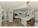 Bright kitchen with white cabinets, stainless steel appliances, and an island with bar seating at 9869 Gulfstream Blvd, Englewood, FL 34224