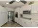 Clean and modern kitchen features stainless steel appliances, recessed lighting, and white cabinets at 9869 Gulfstream Blvd, Englewood, FL 34224
