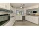 Modern kitchen featuring white cabinetry, stainless steel appliances, and a window with a serene outdoor view at 9869 Gulfstream Blvd, Englewood, FL 34224