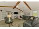 Living room featuring vaulted ceilings with wooden beams and comfortable seating at 9869 Gulfstream Blvd, Englewood, FL 34224