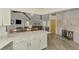 This open concept living space features a connection between the modern kitchen and the cozy living room at 9869 Gulfstream Blvd, Englewood, FL 34224