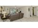 Comfortable living room with sliding glass doors that give a view of the pool outside at 9869 Gulfstream Blvd, Englewood, FL 34224