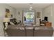 Living room with a sofa, desk, and sliding glass doors that show a pool at 9869 Gulfstream Blvd, Englewood, FL 34224