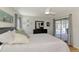 Relaxing main bedroom with a view of the pool area, featuring a dresser and neutral decor at 9869 Gulfstream Blvd, Englewood, FL 34224