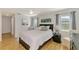 Serene main bedroom with natural light, a cozy bed, and tasteful decor at 9869 Gulfstream Blvd, Englewood, FL 34224