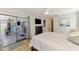 Spacious main bedroom with a view of the lanai, featuring a modern dresser and comfortable furnishings at 9869 Gulfstream Blvd, Englewood, FL 34224