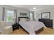 Comfortable main bedroom with neutral tones, abundant natural light, and wood flooring at 9869 Gulfstream Blvd, Englewood, FL 34224