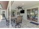 Outdoor patio featuring a full bar, comfortable seating, a TV, and easy access to the pool area at 9869 Gulfstream Blvd, Englewood, FL 34224