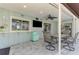 Outdoor patio with a full bar, comfortable seating, and a TV, perfect for relaxed outdoor entertainment at 9869 Gulfstream Blvd, Englewood, FL 34224