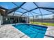 Screened-in pool and outdoor patio area with seating provides a perfect space for entertaining or relaxing at 9869 Gulfstream Blvd, Englewood, FL 34224
