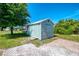 Charming backyard shed with access ramp, offering storage and utility, and situated on a well-maintained property at 9869 Gulfstream Blvd, Englewood, FL 34224