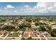 An aerial view showing the property and its neighborhood with lush greenery at 10116 Melanie Ave, Englewood, FL 34224