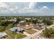 An aerial shot circles the property, showcasing its placement among the neighborhood's serene setting at 10116 Melanie Ave, Englewood, FL 34224