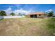 Expansive backyard featuring a view of the home's screened lanai, promising outdoor enjoyment at 10116 Melanie Ave, Englewood, FL 34224